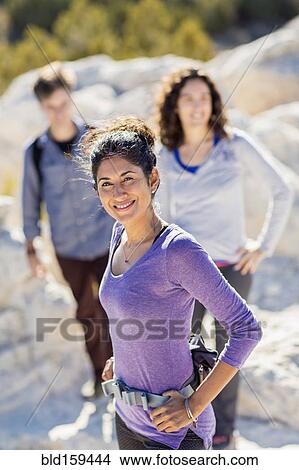 Hikers smiling on rocky hilltop View Large Photo Image Picture - Hikers smiling on rocky hilltop. Fotosearch
