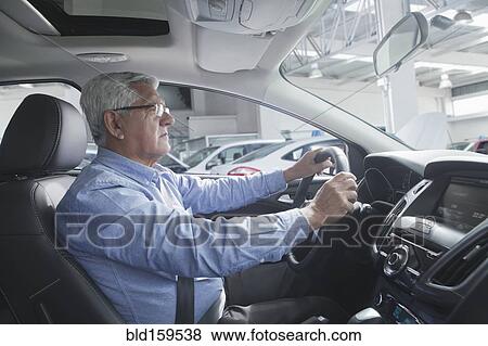 Hispanic customer test driving new car View Large Photo Image Stock Photo - Hispanic customer test driving new car. Fotosearch