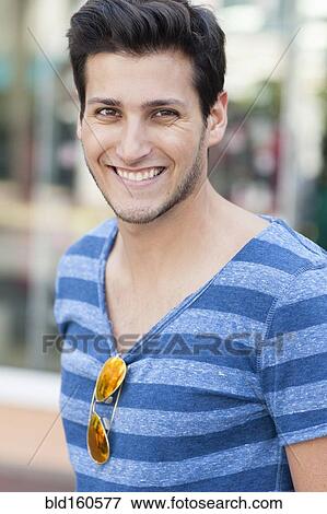 Stock Photo - Hispanic man wearing sunglasses on shirt. Fotosearch