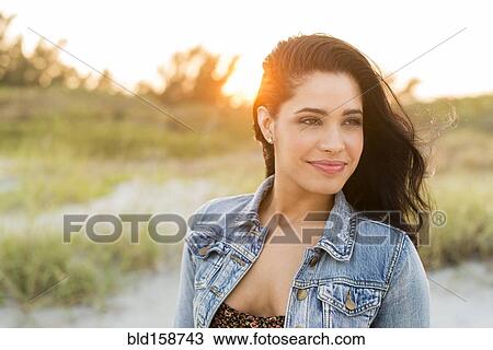 Hispanic woman standing on beach View Large Photo Image Stock Image - Hispanic woman standing on beach. Fotosearch