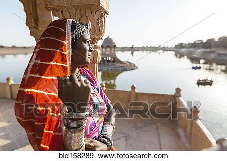 Stock Photo - Indian woman admiring view from monument, Jaisalmer, Rajasthan, India. Fotosearch