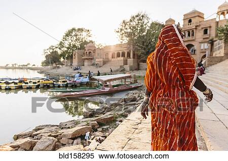 Indian woman walking at waterfront View Large Photo Image Stock Photography - Indian woman walking at waterfront. Fotosearch