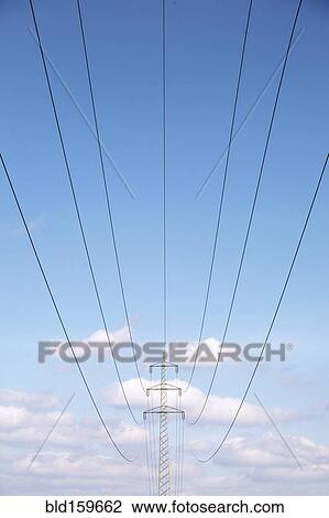 Stock Image - Low angle view of power lines under blue sky. Fotosearch