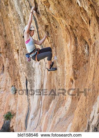 Mixed race girl climbing rock wall View Large Photo Image Stock Photograph - Mixed race girl climbing rock wall. Fotosearch