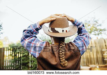 Mixed race girl wearing cowboy costume in backyard View Large Photo Image Stock Image - Mixed race girl wearing cowboy costume in backyard. Fotosearch