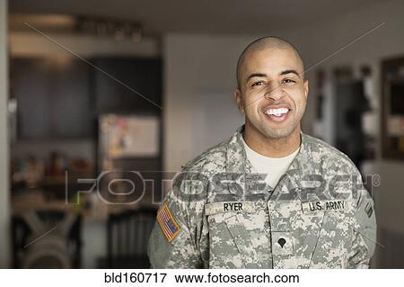 Stock Photo - Mixed race man smiling in living room. Fotosearch