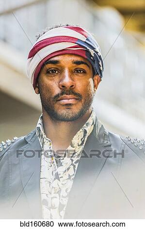 Stock Image - Mixed race man wearing American flag turban. Fotosearch