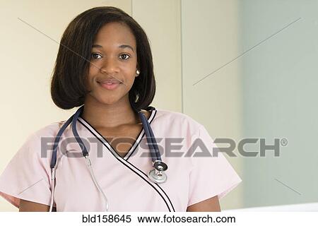 Stock Photography - Mixed race nurse smiling. Fotosearch