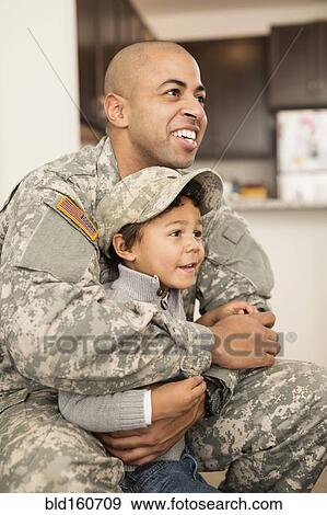 Mixed race soldier father hugging son View Large Photo Image Stock Photo - Mixed race soldier father hugging son. Fotosearch