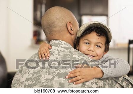 Stock Photo - Mixed race soldier hugging son. Fotosearch