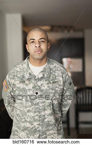 Mixed race soldier standing in living room View Large Photo Image Stock Photograph - Mixed race soldier standing in living room. Fotosearch