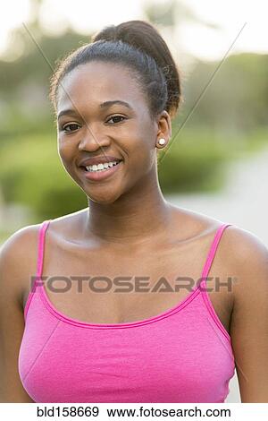 Stock Photo - Mixed race woman smiling outdoors. Fotosearch