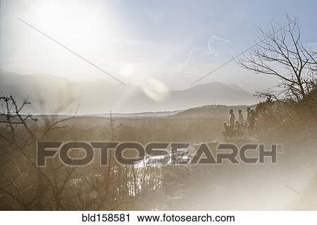 Stock Image - Mountains over river in rural landscape. Fotosearch