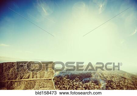 Stock Image - Mountaintops in remote landscape under sunny sky. Fotosearch