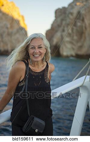 Older Caucasian woman smiling on boat View Large Photo Image Stock Image - Older Caucasian woman smiling on boat. Fotosearch