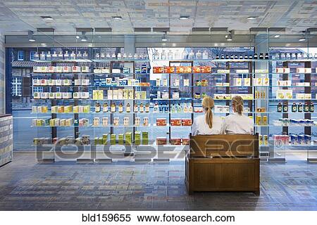 Stock Photography - Pharmacists sitting in modern pharmacy. Fotosearch