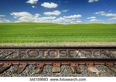 Railroad tracks and rolling hills in rural landscape View Large Photo Image Stock Image - Railroad tracks and rolling hills in rural landscape. Fotosearch