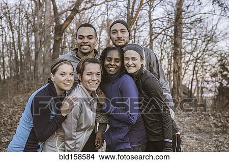 Picture - Runners smiling on forest path. Fotosearch