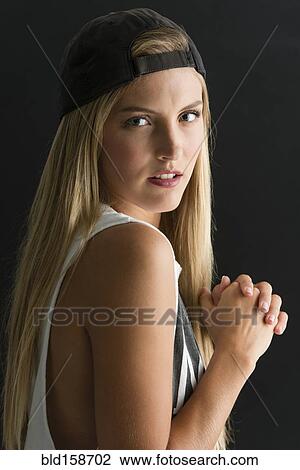 Stock Image - Serious Caucasian woman looking over her shoulder. Fotosearch