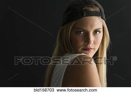 Stock Image - Serious Caucasian woman looking over her shoulder. Fotosearch