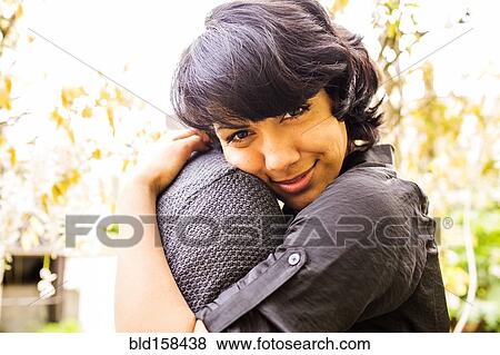 Stock Photo - Smiling couple hugging in park. Fotosearch