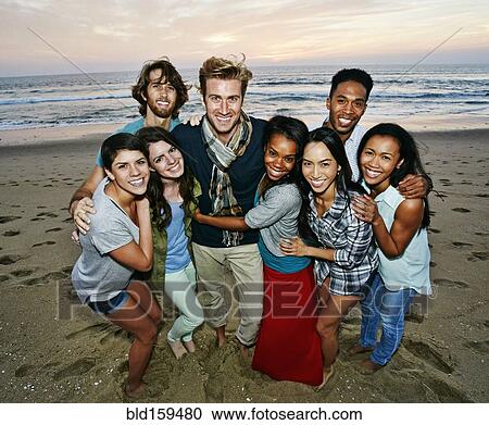 Smiling friends posing on beach View Large Photo Image Stock Image - Smiling friends posing on beach. Fotosearch