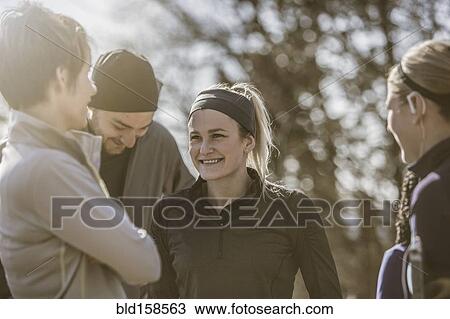 Stock Image - Smiling friends talking outdoors. Fotosearch