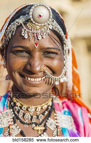 Smiling Indian woman wearing traditional jewelry View Large Photo Image Stock Photography - Smiling Indian woman wearing traditional jewelry. Fotosearch