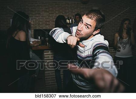 Stock Photo - Smiling man dancing in nightclub. Fotosearch