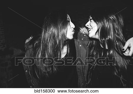 Stock Image - Smiling women laughing at party. Fotosearch