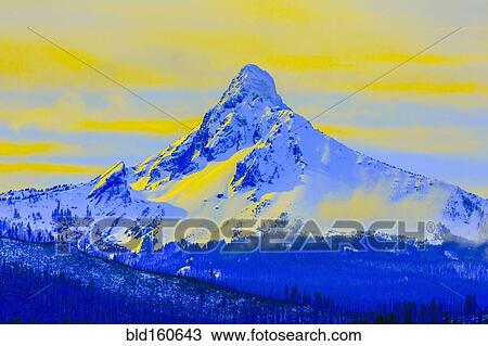 Stock Image - Snowy Mt Washington in yellow sky, Jefferson County, Oregon, United States. Fotosearch