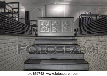 Stock Image - Staircase to counter in clothing store for men. Fotosearch