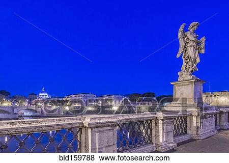Stock Photo - Statue over illuminated bridge at night, Rome, Italy. Fotosearch