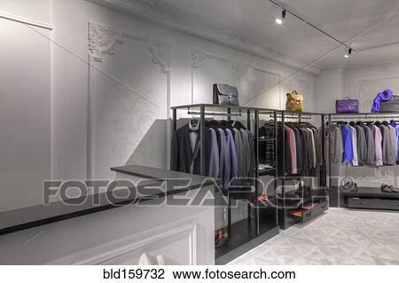 Stock Image - Suits and briefcases in clothing store for men. Fotosearch