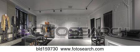 Stock Image - Suits and shoes in clothing store for men. Fotosearch