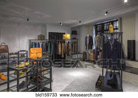 Stock Image - Suits and shoes in clothing store for men. Fotosearch