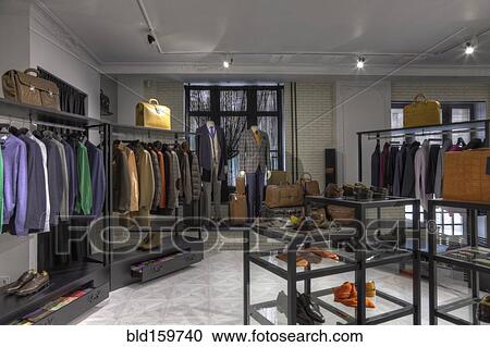 Stock Image - Suits and shoes in clothing store for men. Fotosearch