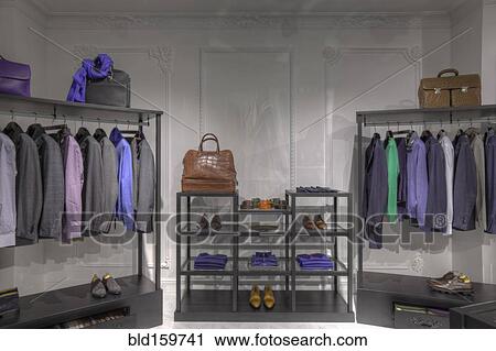 Stock Image - Suits and shoes in clothing store for men. Fotosearch