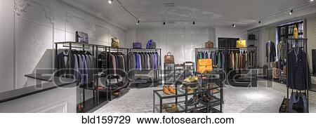 Stock Photo - Suits and shoes in clothing store for men. Fotosearch