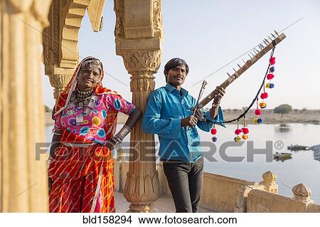 Picture - Traditional Indian couple standing in monument, Jaisalmer, Rajasthan, India. Fotosearch