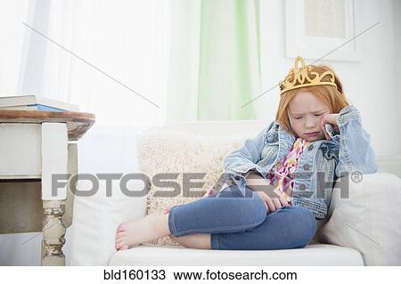 Upset Caucasian girl pouting in armchair View Large Photo Image Stock Image - Upset Caucasian girl pouting in armchair. Fotosearch