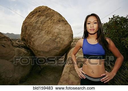 Vietnamese athlete standing near boulders View Large Photo Image Stock Image - Vietnamese athlete standing near boulders. Fotosearch