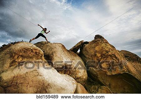 Vietnamese woman running on rocky hilltop View Large Photo Image Stock Photo - Vietnamese woman running on rocky hilltop. Fotosearch