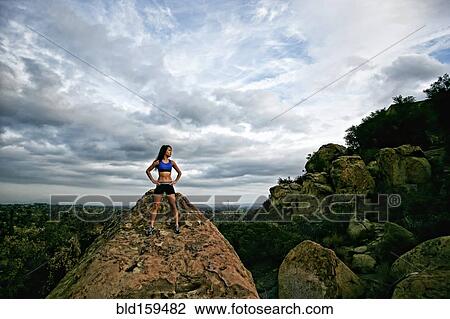 Vietnamese woman standing on rocky hilltop View Large Photo Image Stock Image - Vietnamese woman standing on rocky hilltop. Fotosearch