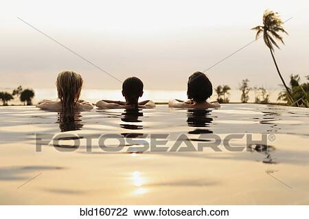 Women admiring scenic view in infinity pool View Large Photo Image Stock Image - Women admiring scenic view in infinity pool. Fotosearch