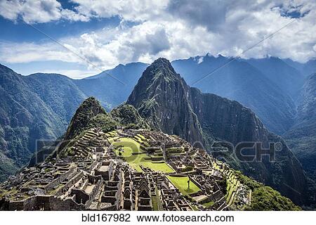 Stock Image - Aerial view of Macchu Picchu ruins in remote landscape, Cusco, Peru. Fotosearch