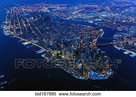 Stock Photography - Aerial view of Manhattan cityscape and river at night, New York, United States. Fotosearch
