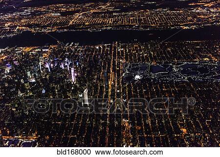 Stock Image - Aerial view of Manhattan cityscape at night, New York, United States. Fotosearch