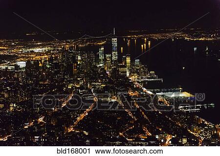 Stock Image - Aerial view of Manhattan cityscape at night, New York, United States. Fotosearch