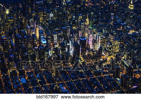 Stock Photo - Aerial view of Manhattan cityscape at night, New York, United States. Fotosearch